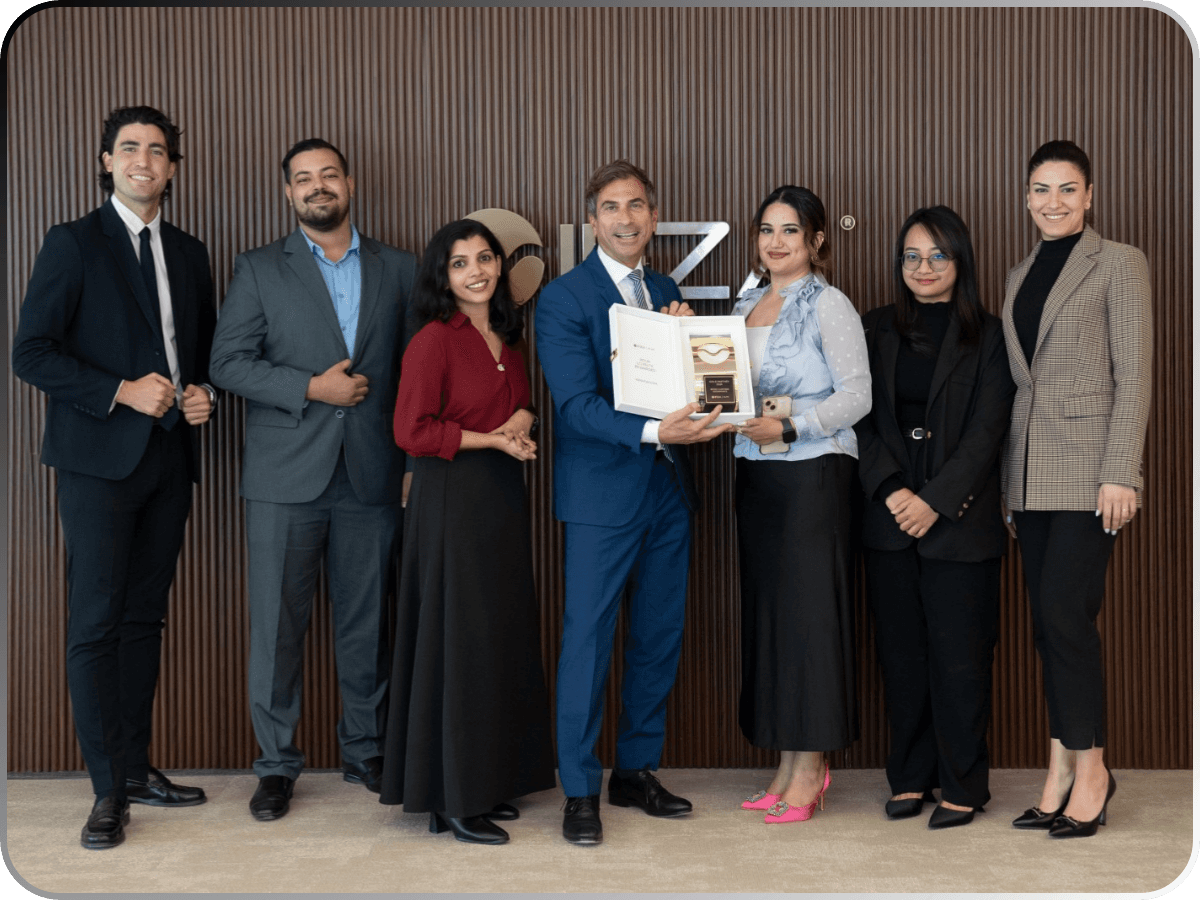 The Bestax Chartered Accountants team in the firm's office, holding a partner recognition award.