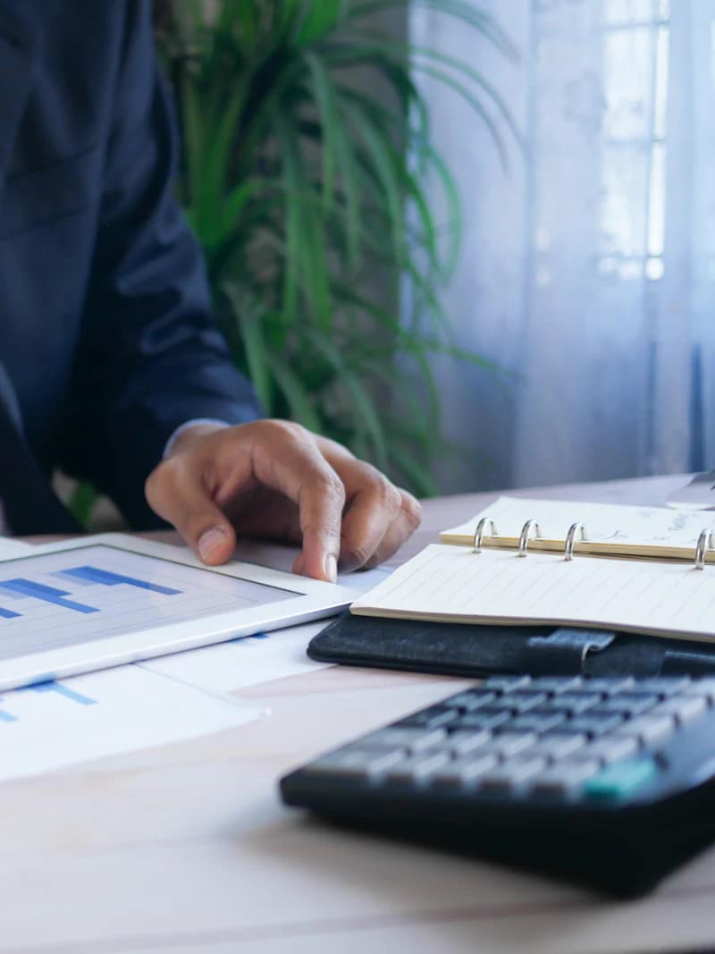 An accountant working through invoices and supporting records at a desk.
