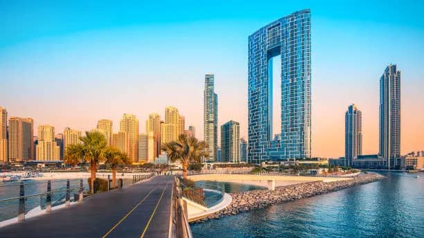 Dubai's waterfront towers at dusk, where many of the free zones Bestax registers clients in are based.