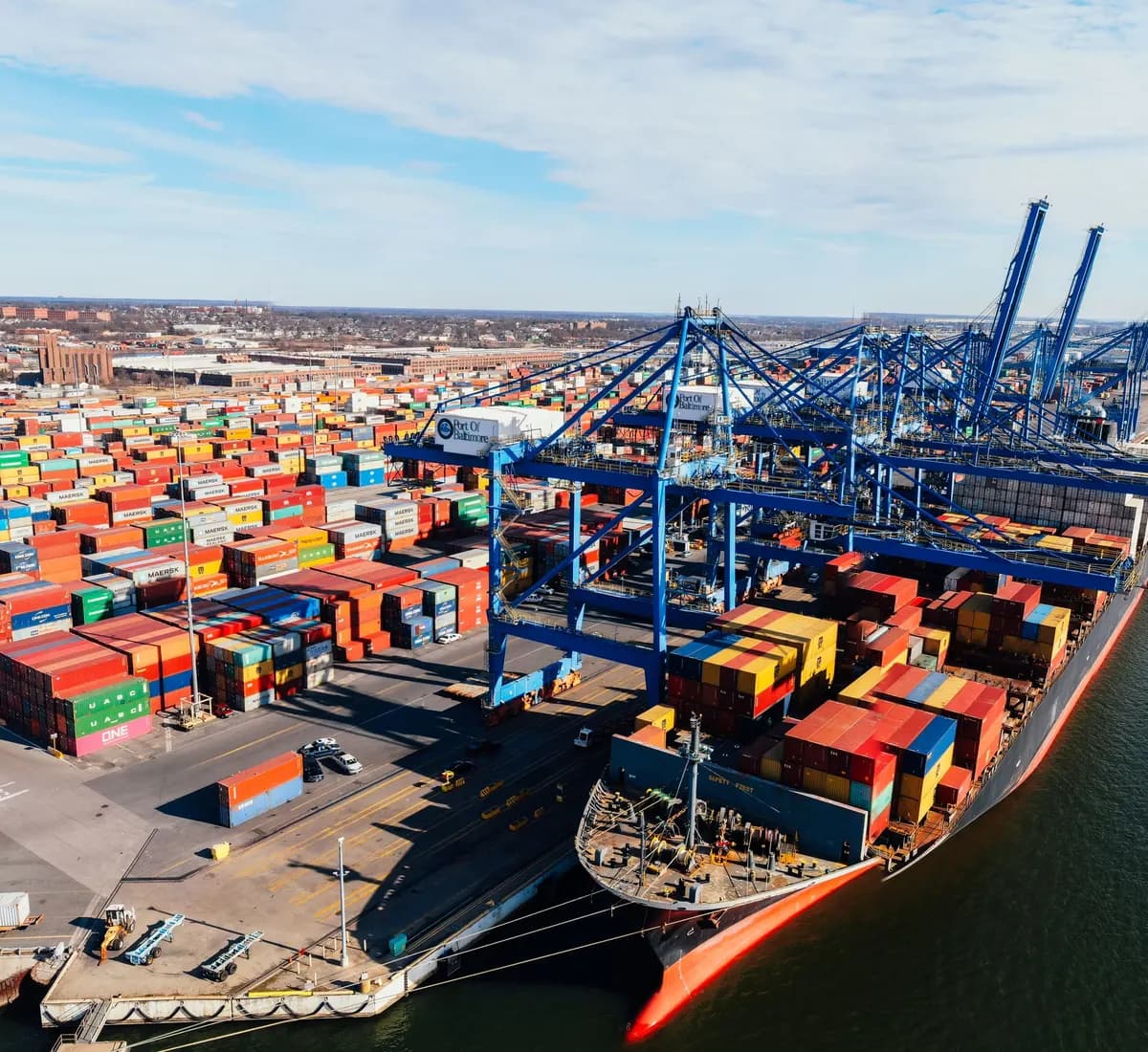 Aerial view of a container port with gantry cranes loading a cargo ship