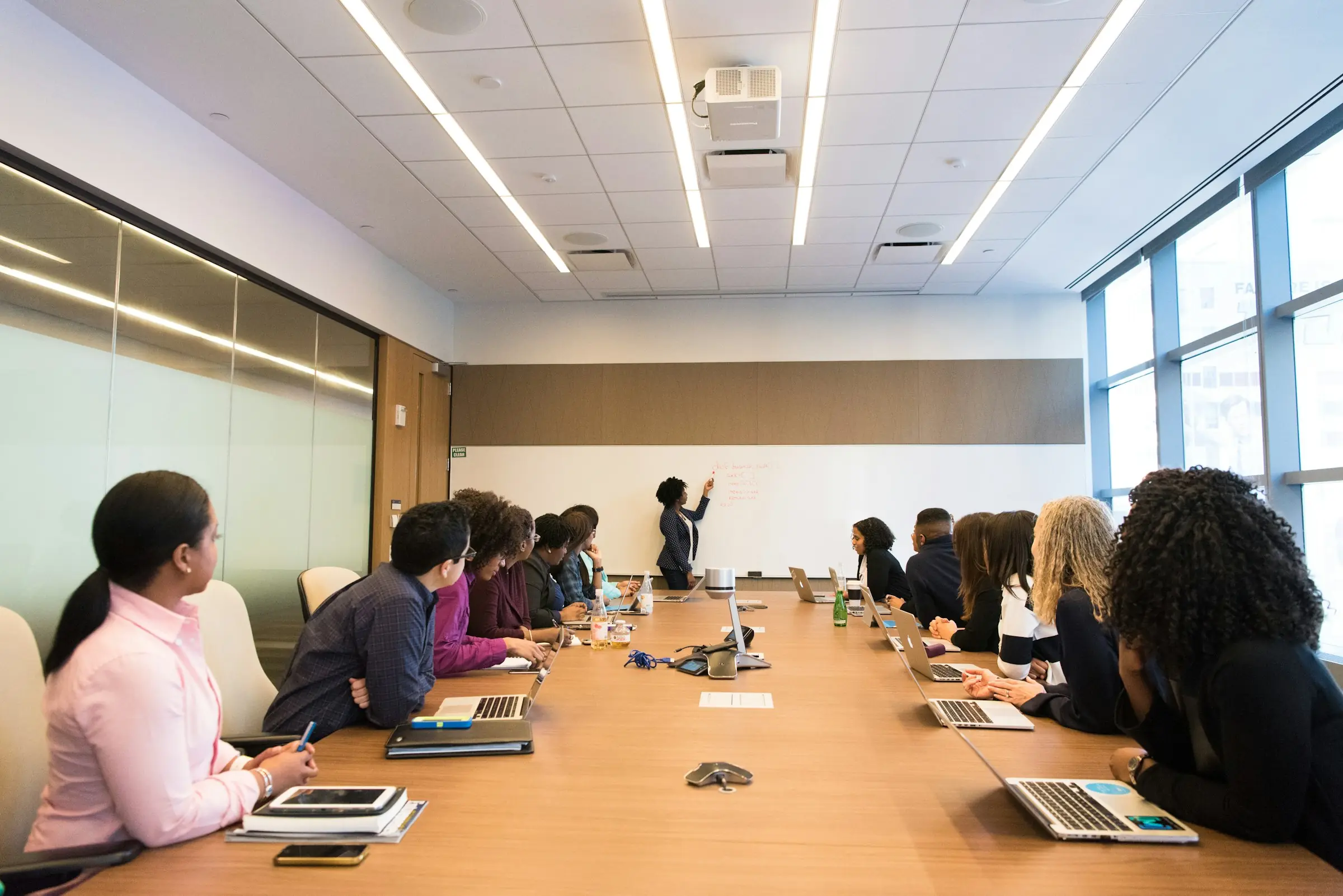 A Bestax team walking a client through a system rollout in a boardroom.