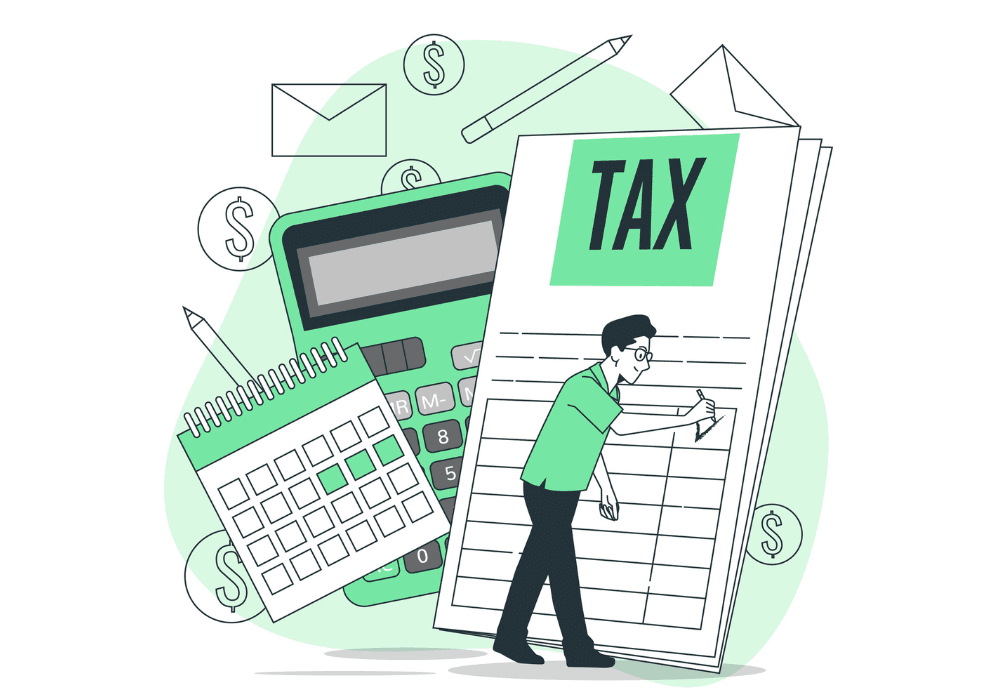 A man sitting at a desk with a calculator and tax book in front of him, preparing financial documents.